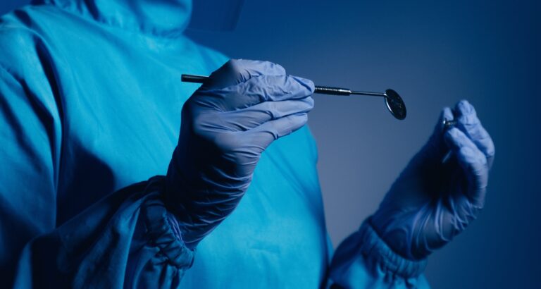Doctor dentist with a medical device in hands