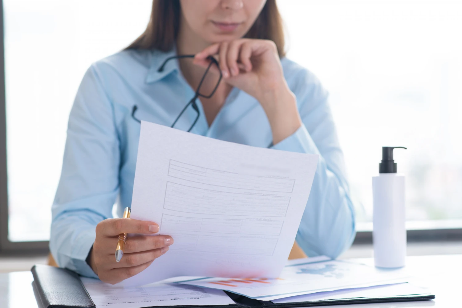 A woman analyzing a cosmetic formulation